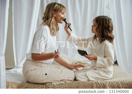 Doing make up. Mother with daughter are at home together Doing make up. Mother with daughter are at home together 131348000