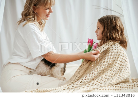 Mother's day. Cute dog. With daughter and flowers. At home together 131348016