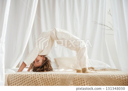 Playing on the bed. Cute little girl is at home 131348030