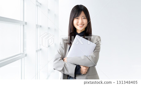 Smiling woman/businesswoman with a laptop Smiling woman/businesswoman with a laptop 131348405