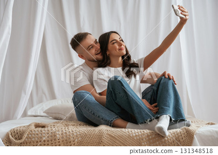 Doing selfie. Young couple are together at home Doing selfie. Young couple are together at home 131348518