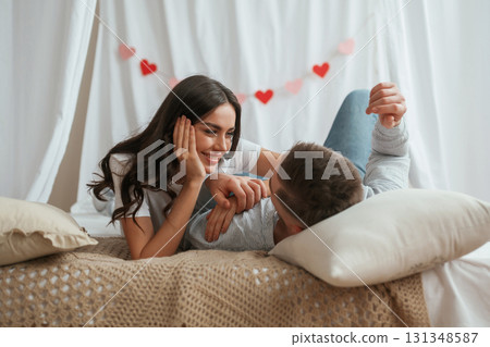 Together on the bed. Young couple are at home Together on the bed. Young couple are at home 131348587