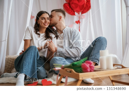 Celebrating Valentine's day holiday. Young couple are together at home Celebrating Valentine's day holiday. Young couple are together at home 131348690
