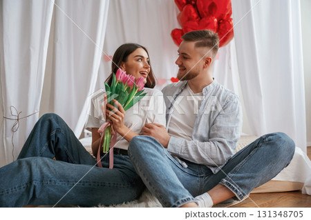 Festive decorations, Valentine's day. Young couple are together at home 131348705