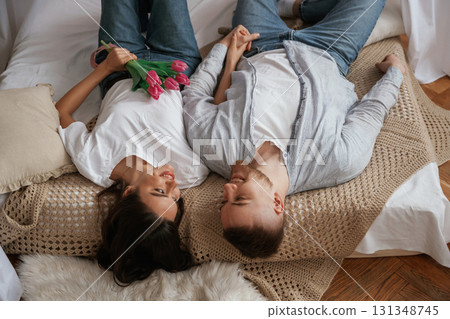 Lying down on the bed. Young couple are together at home Lying down on the bed. Young couple are together at home 131348745