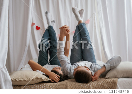 Lying down on the bed. Young couple are together at home 131348746