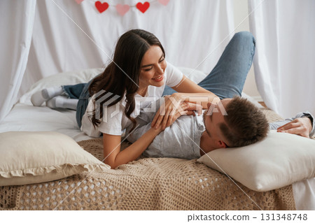 Lying down on the bed. Young couple are together at home 131348748
