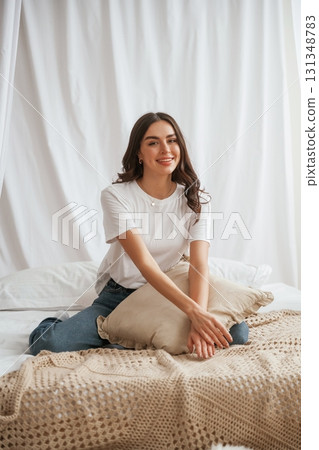 Young beautiful woman is at home on the bed Young beautiful woman is at home on the bed 131348783