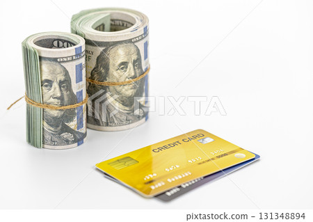 Rolled cash and credit card on white background, financial concept showing money and payment card conveying success and transaction confidence Rolled cash and credit card on white background, financial concept showing money and payment card conveying success and transaction confidence 131348894
