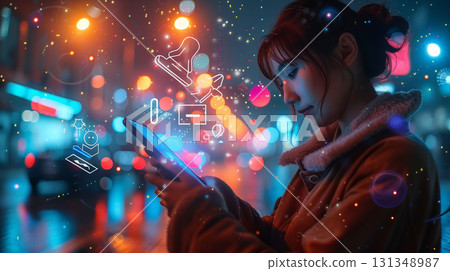 Young woman using smartphone with glowing social media icons in night city lights 131348987