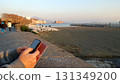 Relaxing with my cell phone in hand on the Naples seafront. 131349200