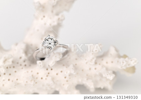 A diamond ring is set in a white coral A diamond ring is set in a white coral 131349310