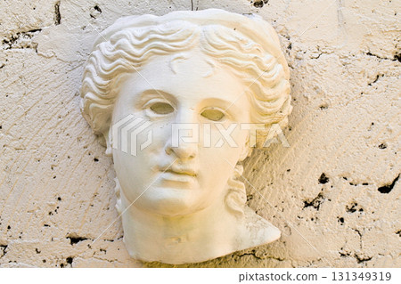A white statue of a woman's head with a black eye A white statue of a woman's head with a black eye 131349319