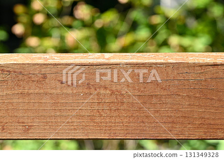 A wooden board with a brown grain and a few scratches A wooden board with a brown grain and a few scratches 131349328