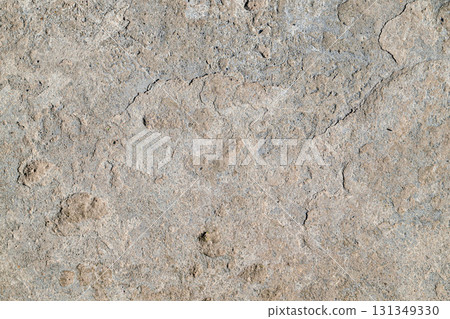 A grey and white stone wall with a lot of holes A grey and white stone wall with a lot of holes 131349330