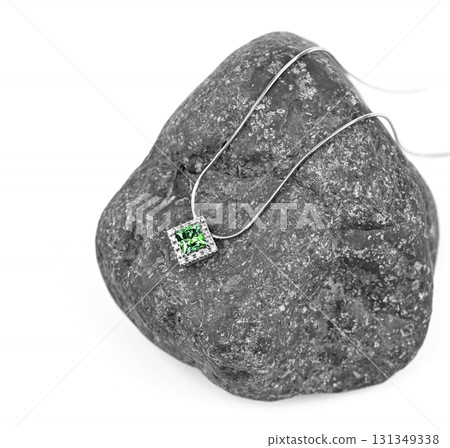 A green emerald necklace is on a rock 131349338