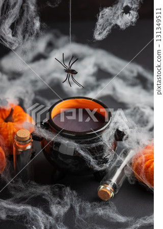 Halloween Cauldron with Pumpkins, Spiders and Cobwebs 131349511