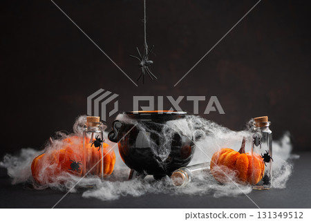 Halloween Cauldron with Pumpkins, Spiders and Cobwebs Halloween Cauldron with Pumpkins, Spiders and Cobwebs 131349512