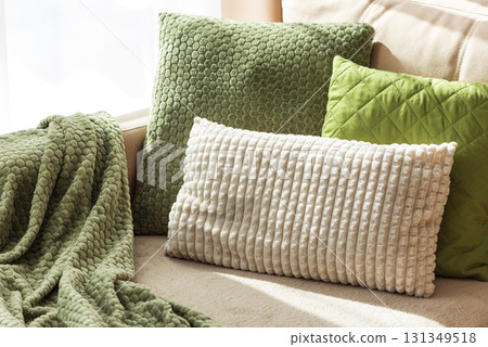 Textured Pillows and Blanket on Cozy Beige Sofa Textured Pillows and Blanket on Cozy Beige Sofa 131349518