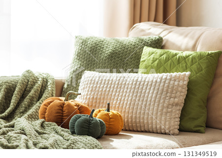 Cozy Autumn Sofa with Fabric Pumpkins and Textured Pillows Cozy Autumn Sofa with Fabric Pumpkins and Textured Pillows 131349519