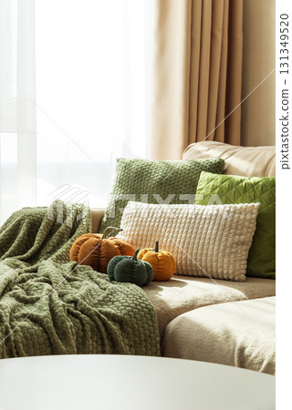 Cozy Autumn Sofa with Fabric Pumpkins and Textured Pillows 131349520