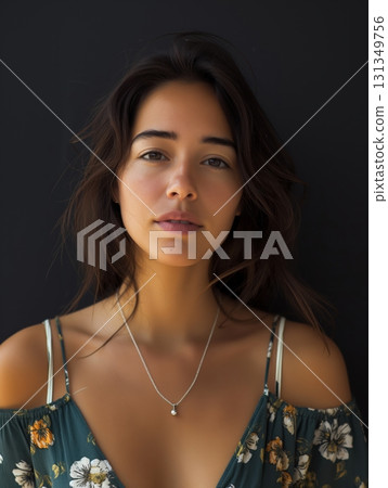 A woman with a necklace is standing in front of a black background 131349756