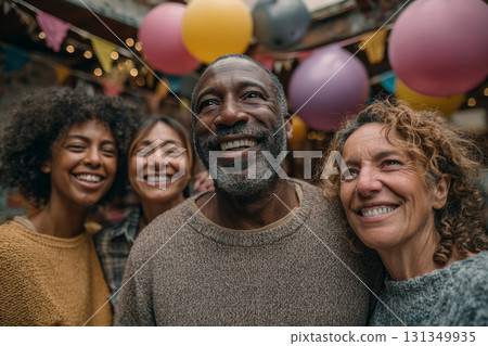 Happy family members smiling together surrounded by balloons during a birthday celebration 131349935