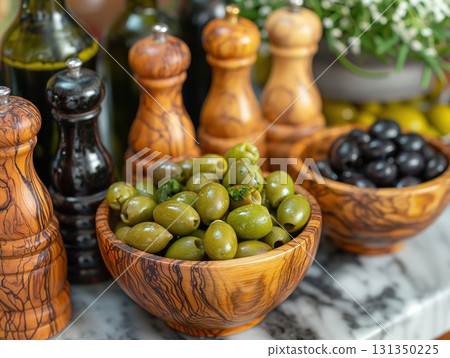 A table with a variety of olive dishes and a few bottles of olive oil 131350225