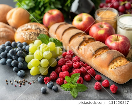 A variety of fruits and bread are displayed on a table 131350227