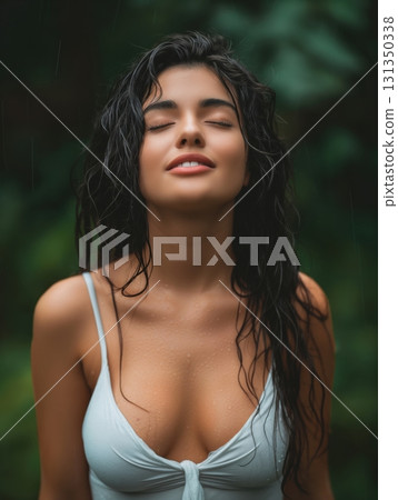 A woman with long hair is smiling and looking at the camera 131350338