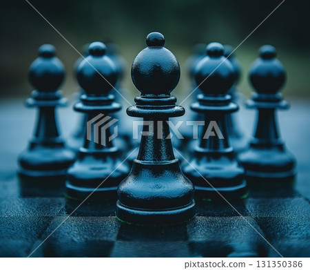 A black chess piece is the center of attention in a row of black chess pieces A black chess piece is the center of attention in a row of black chess pieces 131350386