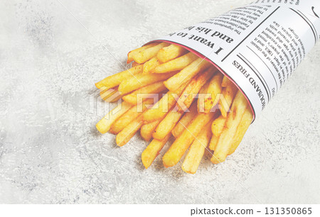 Fried French fries in a paper bag, on an abstract background, without people, in a rustic style, Fried French fries in a paper bag, on an abstract background, without people, in a rustic style, 131350865
