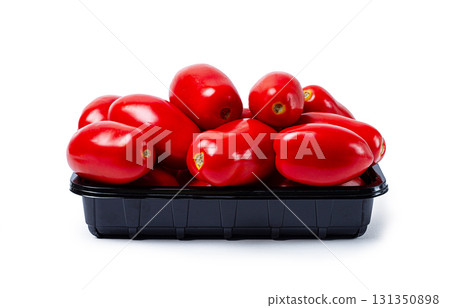 plum-shaped tomatoes, fresh, in a black plastic container, on a white background, isolate, plum-shaped tomatoes, fresh, in a black plastic container, on a white background, isolate, 131350898