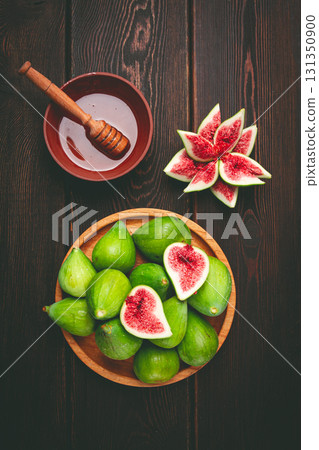 Fresh green figs, honey, top view, on a wooden table, no people, Fresh green figs, honey, top view, on a wooden table, no people, 131350900