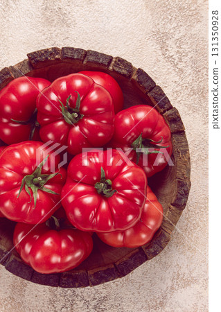 Pink tomatoes, in a rustic wooden bowl, close-up, no people, 131350928