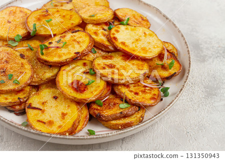 Crispy potato slices, with parmesan cheese and spices, fried in the oven, homemade, no people, 131350943