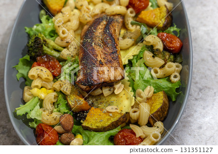 Healthy and delicious: A perfect combination of roasted salmon, fish, rice and salad Healthy and delicious: A perfect combination of roasted salmon, fish, rice and salad 131351127