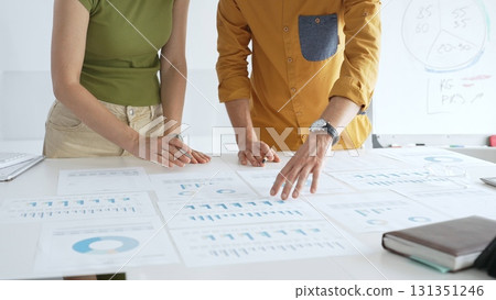 Professional business team members are reviewing financial data, analyzing charts and graphs, during a productive meeting in a modern office. Businesspeople concept Professional business team members are reviewing financial data, analyzing charts and graphs, during a productive meeting in a modern office. Businesspeople concept 131351246