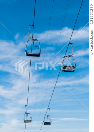 Chair Lift above the mountains and green forest of Bulgaria. Eco tourism. Tourist attraction. Seven Rila lakes. Cable car in Rila Mountains Chair Lift above the mountains and green forest of Bulgaria. Eco tourism. Tourist attraction. Seven Rila lakes. Cable car in Rila Mountains 131351259