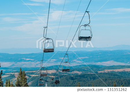 Chair Lift above the mountains and green forest of Bulgaria. Eco tourism. Tourist attraction. Seven Rila lakes. Cable car in Rila Mountains 131351262
