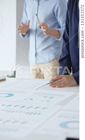 Professional team analyzing financial reports, sharing insights and planning strategic decisions in modern workplace setting. Business people concept Professional team analyzing financial reports, sharing insights and planning strategic decisions in modern workplace setting. Business people concept 131351372