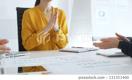 Business colleagues clapping hands after successful presentation or good news during a corporate meeting, celebrating achievement and success in office Business colleagues clapping hands after successful presentation or good news during a corporate meeting, celebrating achievement and success in office 131351400