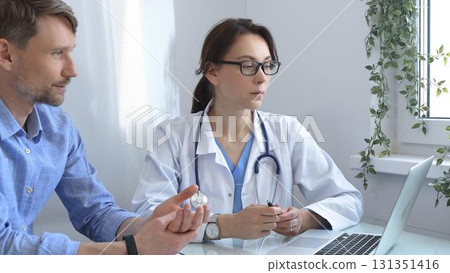 Female doctor consulting with patient in medical office, using laptop to provide healthcare advice and support while discussing treatment options in a professional setting. Medicine concept Female doctor consulting with patient in medical office, using laptop to provide healthcare advice and support while discussing treatment options in a professional setting. Medicine concept 131351416