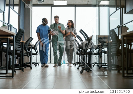 Walking together. Group of doctors are indoors Walking together. Group of doctors are indoors 131351790