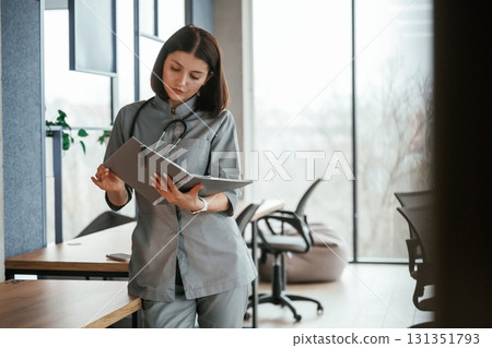 Female doctor in coat is indoors Female doctor in coat is indoors 131351793