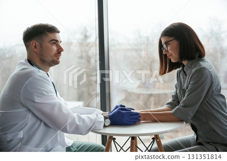 Two doctors are holding hands indoors Two doctors are holding hands indoors 131351814
