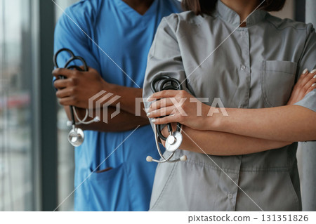 Man and woman doctors are standing together indoors with stethoscope 131351826