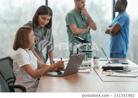 By the table. Group of doctors are together indoors By the table. Group of doctors are together indoors 131351902
