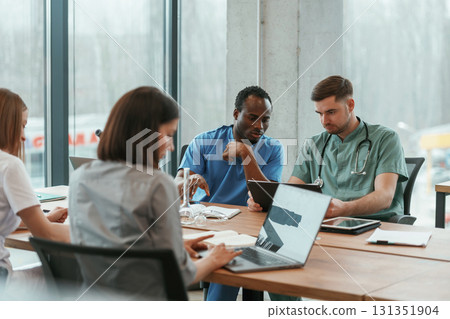 By the table. Group of doctors are together indoors 131351904