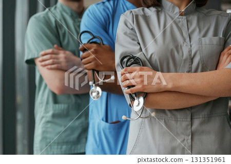 With stethoscope. Group of doctors are together indoors With stethoscope. Group of doctors are together indoors 131351961